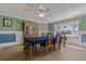 Traditional dining room with a wood china cabinet, a blue tablecloth, and outside view at 6754 Winterset Gardens Rd, Winter Haven, FL 33884