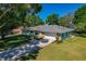 Charming single-story home with a well-manicured lawn and a two-car garage at 6754 Winterset Gardens Rd, Winter Haven, FL 33884
