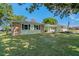 Charming single-story home with a well-manicured lawn and stone accents at 6754 Winterset Gardens Rd, Winter Haven, FL 33884