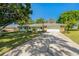 Inviting home exterior with a spacious driveway and mature trees at 6754 Winterset Gardens Rd, Winter Haven, FL 33884