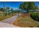 Gated property entrance featuring brickwork and views of the lake at 6754 Winterset Gardens Rd, Winter Haven, FL 33884