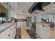 Well-lit kitchen featuring stainless steel appliances, white cabinets, and a large window for natural light at 6754 Winterset Gardens Rd, Winter Haven, FL 33884