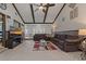 Open living room area showcasing vaulted ceilings, wood beams, and lots of natural light at 6754 Winterset Gardens Rd, Winter Haven, FL 33884
