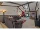 Spacious living room with wood beam vaulted ceilings, and cozy fireplace, and stylish decor at 6754 Winterset Gardens Rd, Winter Haven, FL 33884