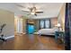 Spacious main bedroom with wood floors, a ceiling fan, and a blue dresser at 6754 Winterset Gardens Rd, Winter Haven, FL 33884