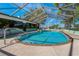 Sparkling pool with screened enclosure and seating area for relaxation or entertaining outdoors at 6754 Winterset Gardens Rd, Winter Haven, FL 33884