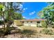 Backyard features a patio area and established trees that provide ample shade and a private retreat at 799 W Lake Otis Dr, Winter Haven, FL 33880
