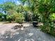 The backyard provides a grill and shaded seating area for outdoor cooking and relaxation at 799 W Lake Otis Dr, Winter Haven, FL 33880