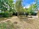 Lush backyard features mature trees, offering shade and a tranquil outdoor space at 799 W Lake Otis Dr, Winter Haven, FL 33880