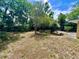 Spacious backyard with mature landscaping and patio, creating a private outdoor oasis at 799 W Lake Otis Dr, Winter Haven, FL 33880