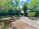 Backyard setting features a fire pit and patio area for relaxing or entertaining outdoors at 799 W Lake Otis Dr, Winter Haven, FL 33880