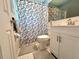 This bathroom features a decorative shower curtain, vanity, and soft grey rugs at 799 W Lake Otis Dr, Winter Haven, FL 33880