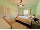 Cozy bedroom features light green walls and multiple closets for ample storage at 799 W Lake Otis Dr, Winter Haven, FL 33880