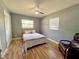 This bedroom offers neutral walls, warm floors, a fan, and natural light at 799 W Lake Otis Dr, Winter Haven, FL 33880