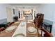 Spacious dining room with an elegant table setting and vintage furniture, leading into the kitchen at 799 W Lake Otis Dr, Winter Haven, FL 33880