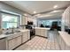 Bright kitchen with stainless steel appliances, tile floors, and a view to the dining room at 799 W Lake Otis Dr, Winter Haven, FL 33880