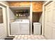 Functional laundry room with washer, dryer, storage cabinets, and ample space at 799 W Lake Otis Dr, Winter Haven, FL 33880