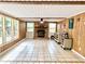 Large living room features a stone fireplace, ceiling fan, and three large windows at 799 W Lake Otis Dr, Winter Haven, FL 33880