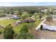 Aerial view showcases the property with circular driveway, greenery, and scenic surroundings at 8947 Oakwood Dr, Lake Wales, FL 33898