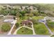 Aerial view of property with circular driveway, manicured lawn, and mature trees at 8947 Oakwood Dr, Lake Wales, FL 33898