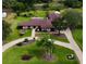 Sprawling property with lush landscaping, long driveway, and charming ranch-style home in a serene, park-like setting at 8947 Oakwood Dr, Lake Wales, FL 33898