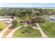 Aerial view of property with circular driveway and landscaping surrounded by trees and a serene backdrop at 8947 Oakwood Dr, Lake Wales, FL 33898