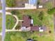 Aerial view of home showcasing lush greenery, circular driveway, and mature trees at 8947 Oakwood Dr, Lake Wales, FL 33898