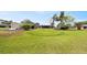 Sprawling backyard showcasing lush greenery, mature trees, and a detached shed enhances the property's appeal at 8947 Oakwood Dr, Lake Wales, FL 33898