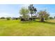 Spacious backyard featuring mature trees and landscaping, offering a serene and private outdoor space at 8947 Oakwood Dr, Lake Wales, FL 33898