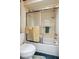 Bathtub with shower and glass sliding doors, with tiled walls at 8947 Oakwood Dr, Lake Wales, FL 33898
