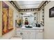 Traditional bathroom vanity with mirror and wallpaper accents at 8947 Oakwood Dr, Lake Wales, FL 33898