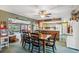 Spacious dining room with a wooden table, open to a sunroom and kitchen at 8947 Oakwood Dr, Lake Wales, FL 33898