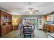 Inviting dining room with a wooden table, ceiling fan, and view of an open floor plan at 8947 Oakwood Dr, Lake Wales, FL 33898