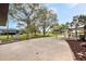 Long driveway with covered parking surrounded by mature trees, lawn and landscaping at 8947 Oakwood Dr, Lake Wales, FL 33898