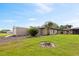 Exterior view of home with a well-manicured lawn and a separate outbuilding offers space and functionality at 8947 Oakwood Dr, Lake Wales, FL 33898