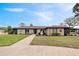 Ranch-style home with well-maintained landscaping and a charming front entrance at 8947 Oakwood Dr, Lake Wales, FL 33898