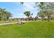 Well-maintained ranch-style home with a lush green lawn and mature trees at 8947 Oakwood Dr, Lake Wales, FL 33898