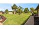 Well-maintained front yard with lush green grass and mature trees enhances the curb appeal of the property at 8947 Oakwood Dr, Lake Wales, FL 33898