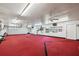 Large garage space with custom red carpet and ample room for work or projects at 8947 Oakwood Dr, Lake Wales, FL 33898