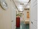 Hallway with tiled floors and decorative walls leading to a bathroom with dual sinks at 8947 Oakwood Dr, Lake Wales, FL 33898