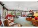 Living room with large windows, ceiling fans, and comfortable seating, perfect for relaxation at 8947 Oakwood Dr, Lake Wales, FL 33898