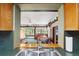 Kitchen pass-through to a room filled with natural light, plants, and comfortable seating at 8947 Oakwood Dr, Lake Wales, FL 33898