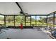 Screened-in lanai providing an airy view of the backyard landscaping at 8947 Oakwood Dr, Lake Wales, FL 33898