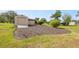 Exterior view of storage shed with wood ramp and landscaping at 8947 Oakwood Dr, Lake Wales, FL 33898