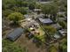 Expansive aerial view showcases the property's layout, surrounding greenery, and highlighting the backyard pool at 903 S Lakeview Ave, Bartow, FL 33830