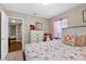 Bedroom with floral bedding, a ceiling light, and natural light from the window at 903 S Lakeview Ave, Bartow, FL 33830