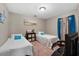 Bedroom featuring twin beds, a desk, and natural light from the window at 903 S Lakeview Ave, Bartow, FL 33830