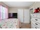 Bedroom with a floral bedspread, a TV, and doors leading to other rooms at 903 S Lakeview Ave, Bartow, FL 33830