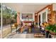 The home's welcoming front porch is decorated with a bench, table, and various knick-knacks at 903 S Lakeview Ave, Bartow, FL 33830