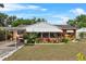 Charming single-story home with cozy porch and lush, landscaped front yard, perfect for relaxed outdoor living at 903 S Lakeview Ave, Bartow, FL 33830